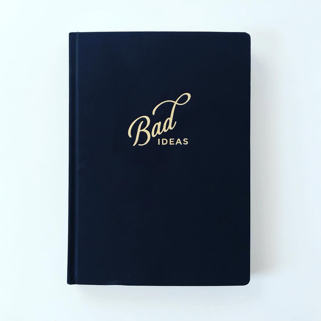 Bad Ideas notebook with IDEAS inscribed on the cover